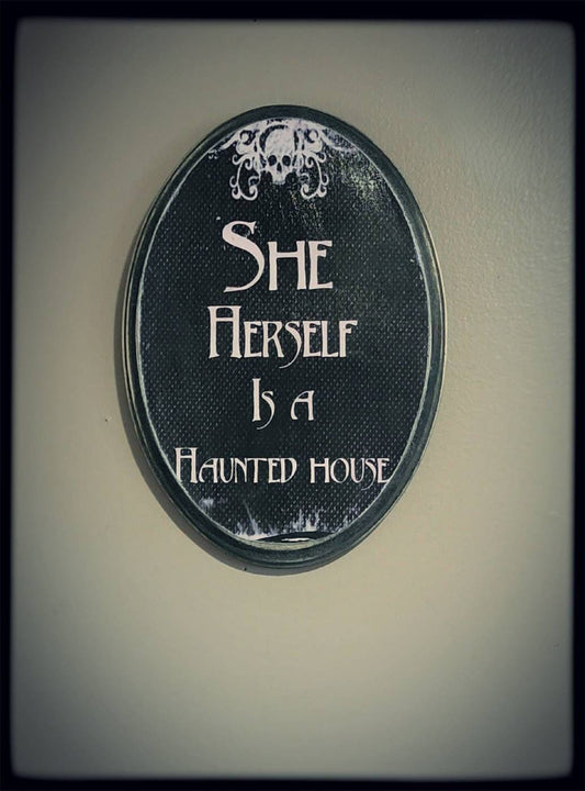 She herself is a haunted house plaque